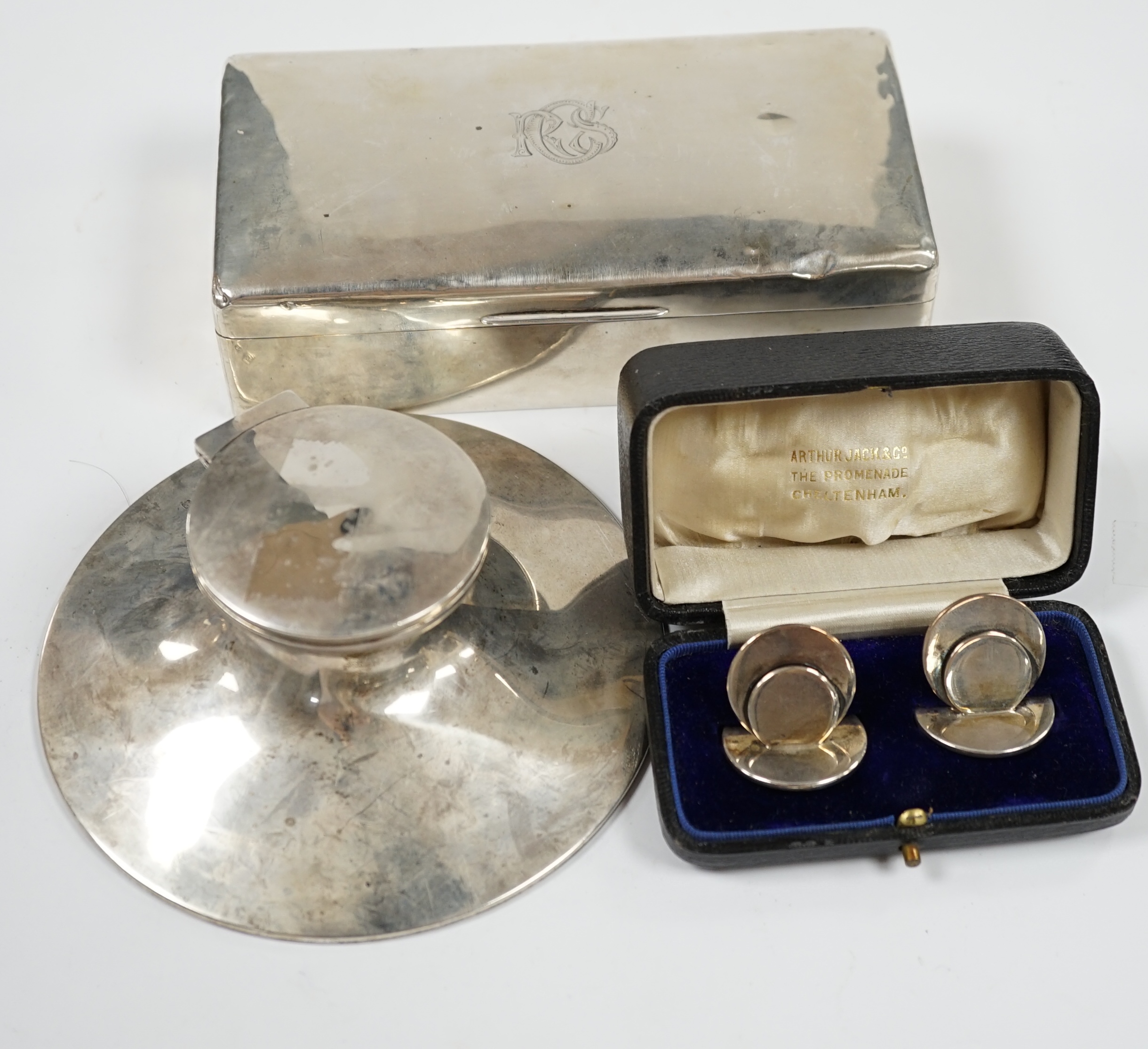 A silver mounted capstan inkwell, Birmingham, 1914, a silver mounted cigarette box and a cased pair of silver menu holders. Condition - poor to fair